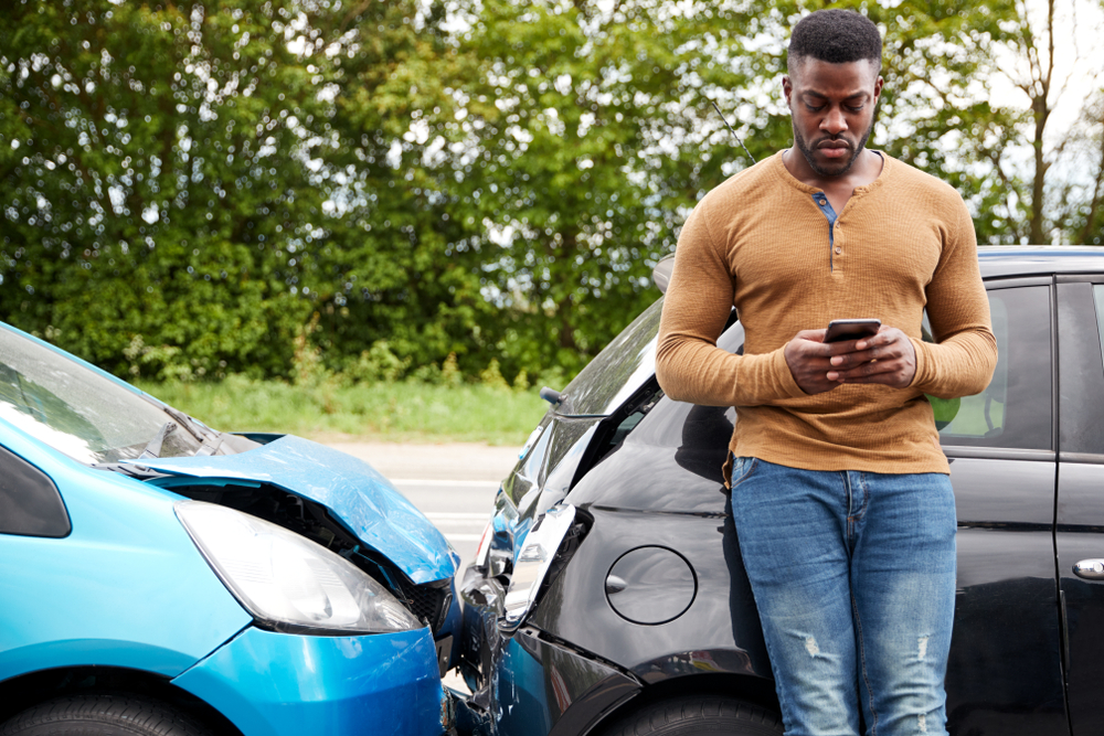 Man standing next to car accident - Lasky Justus Law - Your Savannah Law Firm for car wrecks and personal injury