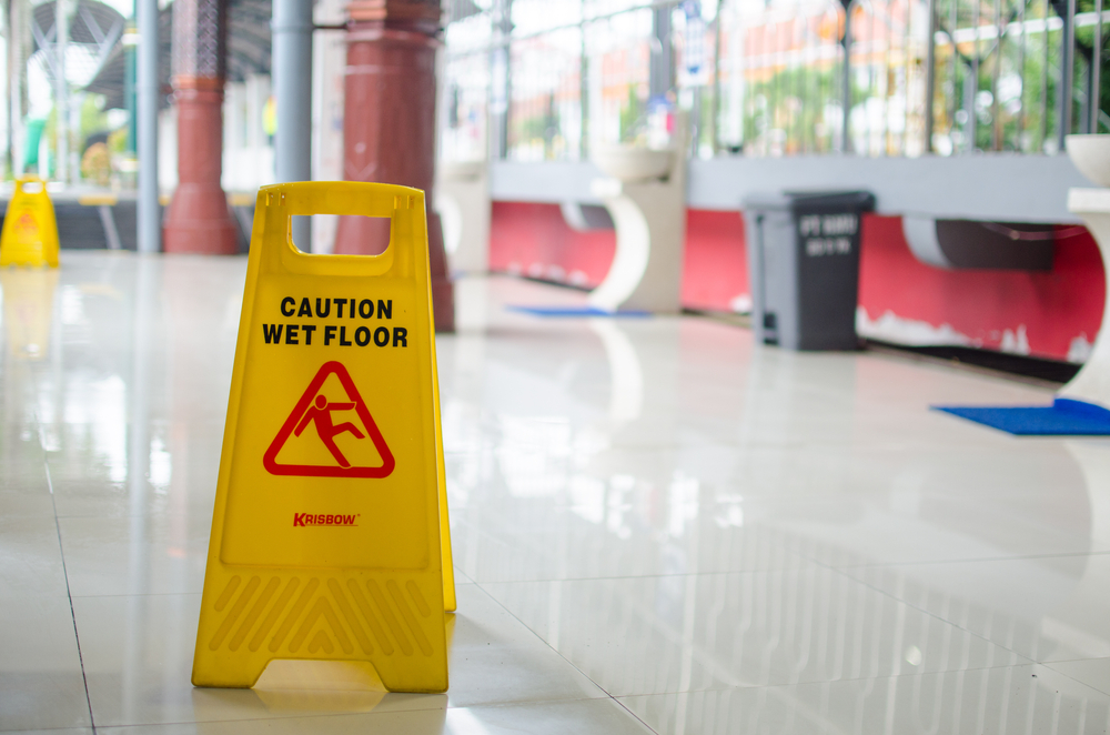 Caution wet floor sign in a public space - Lasky Justus Law - Your Savannah Law Firm for personal injury